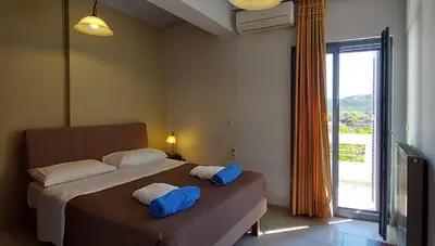 a bedroom with a bed with blue towels on it at Villa 