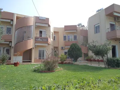 an apartment building with a yard in front of it at Melia Studios in Kato Daratso