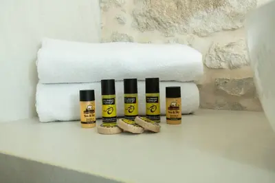 a group of four bottles of essential oils next to towels at Kamartos Villa 1 in Áyios Yeóryios