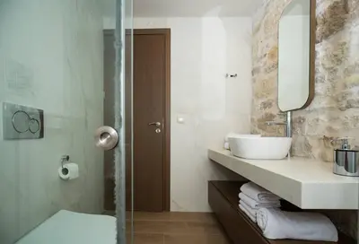 a bathroom with a sink and a mirror at Kamartos Villa 1 in Áyios Yeóryios
