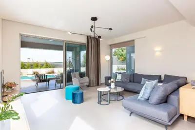 a living room with a couch and a table at Sissy Luxury Villa Chania in Plataniás
