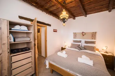 a bedroom with a bed with two towels on it at ARADENA TRADITIONAL House 2 in Arádhaina