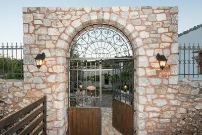 an entrance to a stone building with a gate at ARADENA TRADITIONAL House 2 in Arádhaina