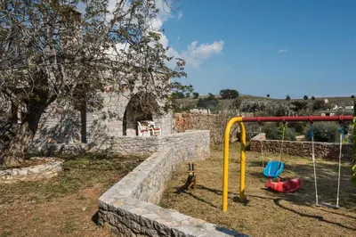 a park with a playground with a rock wall at ARADENA TRADITIONAL House 2 in Arádhaina