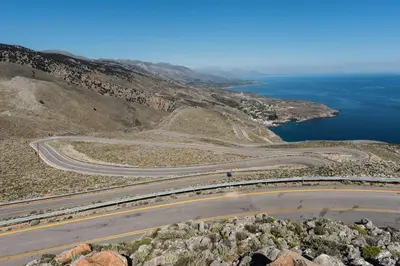 an aerial view of a road on a hill with the ocean at ARADENA TRADITIONAL House 2 in Arádhaina