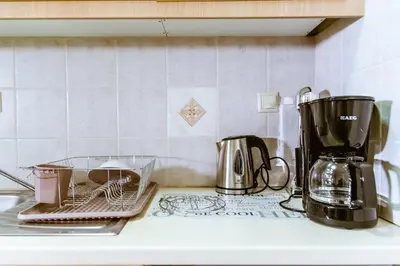 a kitchen counter with a toaster and a coffee maker at Lazaretta studio in Chania Town