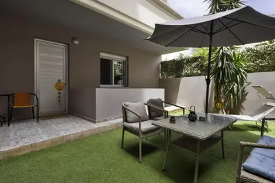 a patio with a table and chairs and an umbrella at Lazaretta studio in Chania Town