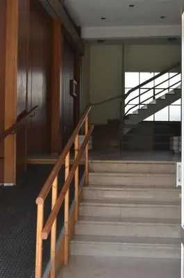 a set of stairs in a building with a railing at Botonis Bright Spacious Apartment in Chania Town