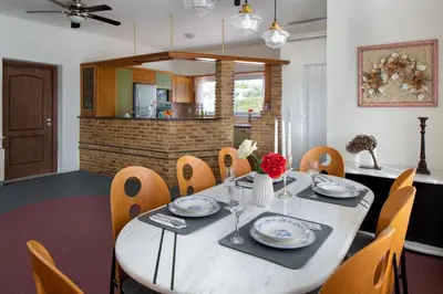 a dining room with a table and chairs at Villa Elihrisos in Chorafakia