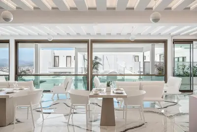 a dining room with white chairs and tables and windows at Lagon Life Spirit Boutique Hotel - Adults Only in Chania Town
