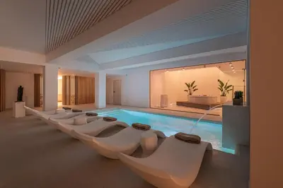 a pool with a row of chairs and a swimming pool at Lagon Life Spirit Boutique Hotel - Adults Only in Chania Town