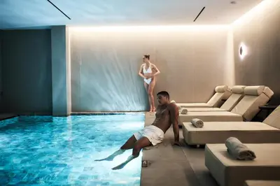 a man and a woman standing in a swimming pool at Myrion Beach Resort & Spa - Adults Only in Gerani Chanion