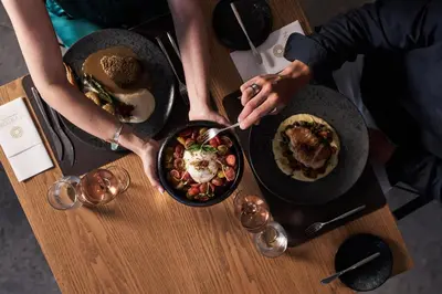 a group of people eating food on a table at Myrion Beach Resort & Spa - Adults Only in Gerani Chanion