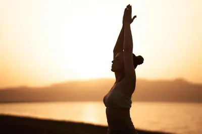 a woman doing yoga on the beach at sunset at Myrion Beach Resort & Spa - Adults Only in Gerani Chanion