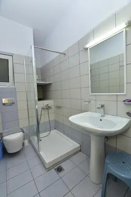 a bathroom with a sink and a shower and a toilet at Paleochora Elizabeth Apartments in Palaiochóra