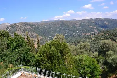 a viewing platform with trees and mountains in the background at Polios in Avdhoulianá