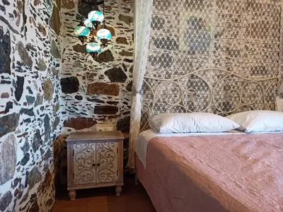 a bedroom with a bed and a night stand with a bed sidx sidx at Polios in Avdhoulianá