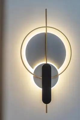 a black and gold chandelier hanging from a wall at Manos Studios in Palaiochóra
