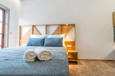 a bedroom with a bed with towels on it at Manos Studios in Palaiochóra