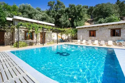 a swimming pool in front of a villa at Villa Talos in Palaiochóra