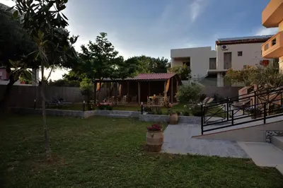 a backyard of a house with a gazebo at Kosmos A.G.K Studios-Apts in Kato Daratso