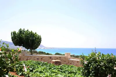 a retaining wall with a view of the ocean at Romantica Apartments in Falasarna