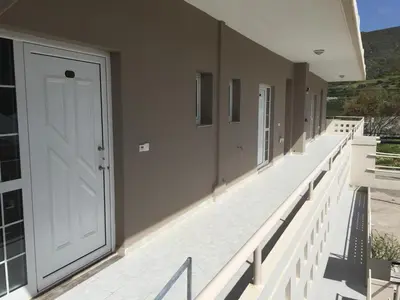 a hallway with a white door on a building at Falassarna Beach studios&apartments in Falasarna