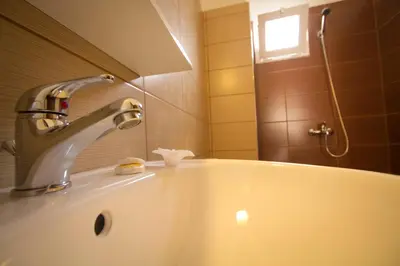 a bathroom with a sink and a faucet at Falassarna Beach studios&apartments in Falasarna