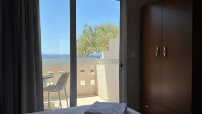 a bedroom with a view of a balcony at Falassarna Beach studios&apartments in Falasarna