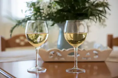 two glasses of white wine sitting on a table at Hermes Sea View in Stalos