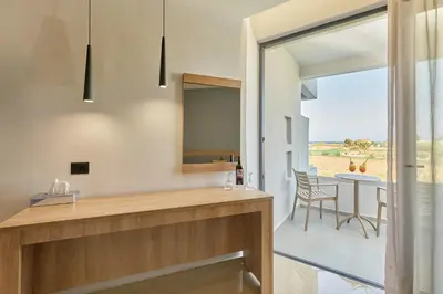 a kitchen with a view of a table and chairs at Galini Palace in Kolymvari
