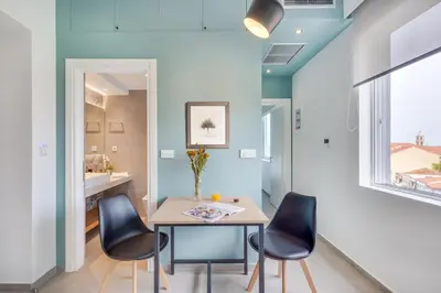 a kitchen and dining room with a table and chairs at Koukou Central Apt -Fast WIFI- 5' to Old Town in Chania Town