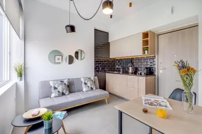 a living room with a couch and a table at Koukou Central Apt -Fast WIFI- 5' to Old Town in Chania Town