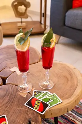 two cocktails sitting on top of a wooden table at LOTOS - Luxury Apartments in Kounoupidhianá