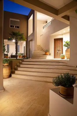 a lobby with stairs and potted plants in a building at LOTOS - Luxury Apartments in Kounoupidhianá
