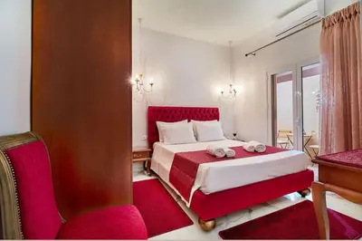 a bedroom with a bed and a desk and a window at Modern Luxury Studio Near Beach & Old Harbor Fast WiFi Private Veranda in Chania Town