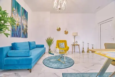 a living room with a blue couch and a table at Modern Luxury Studio Near Beach & Old Harbor Fast WiFi Private Veranda in Chania Town