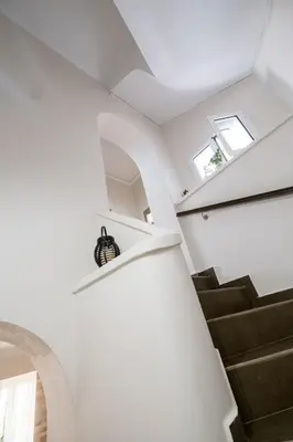 a staircase in a house with white walls and ceilings at Home with Courtyard in Beating Heart of old Town! in Chania Town