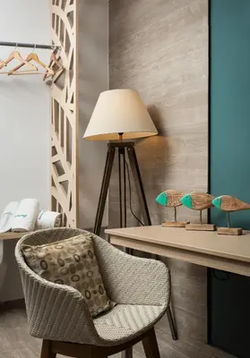 a chair and a table with a lamp at Boutique Home -Splantzia-Roof Garden in Chania Town