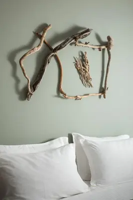 a branch mounted on a wall above a bed at Boutique Home -Splantzia-Roof Garden in Chania Town