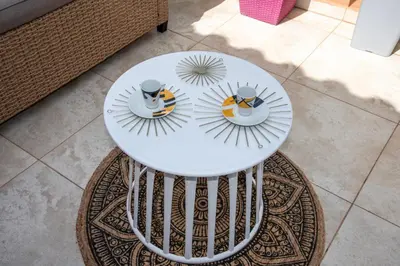 a white table with two plates on top of a rug at Boutique Home -Splantzia-Roof Garden in Chania Town
