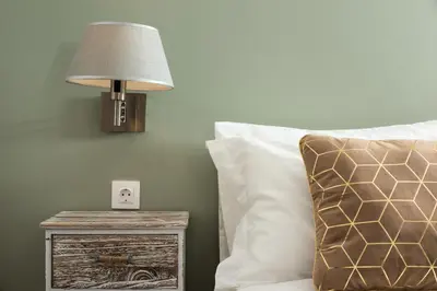 a lamp on a night stand next to a bed at Boutique Home -Splantzia-Roof Garden in Chania Town