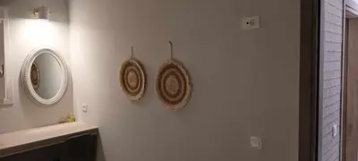a bathroom with two hats hanging on a wall at Chania Design Suites in Chania Town