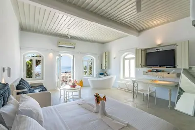 a living room with a couch and a tv at Samaria by the Sea in Khóra Sfakíon