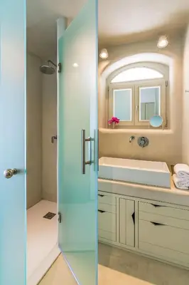 a bathroom with a sink and a mirror at Samaria by the Sea in Khóra Sfakíon