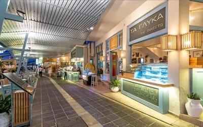 a shopping mall with people walking through it at Samaria by the Sea in Khóra Sfakíon