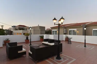 a patio with couches and lights on a building at Okeanis II in Kato Daratso