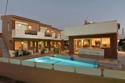 a house with a swimming pool in front of a house at Okeanis II in Kato Daratso