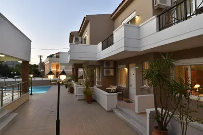 a house with a courtyard and a swimming pool at Okeanis II in Kato Daratso