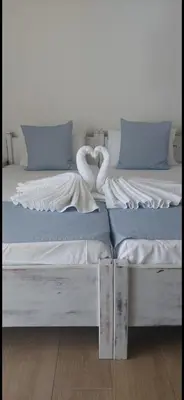two beds sitting next to each other in a room at Maria's Hotel in Palaiochóra